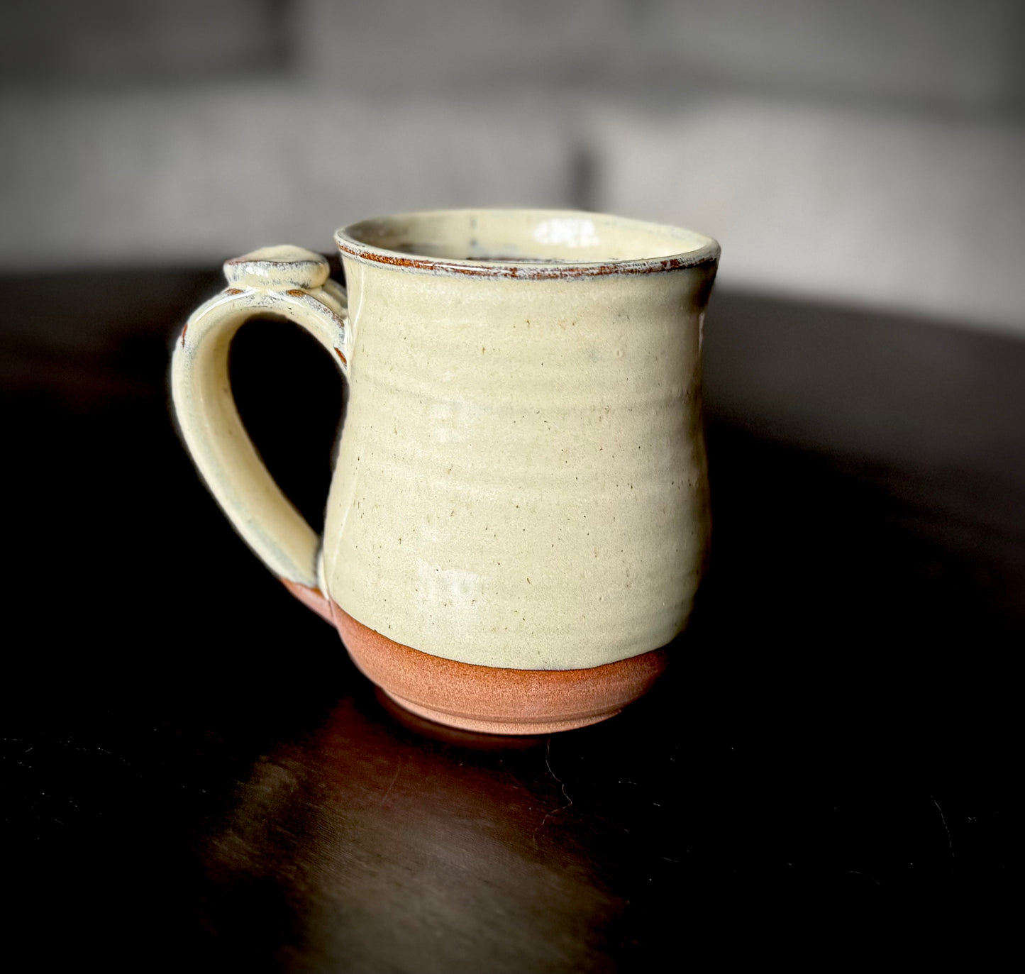 curvy mug cream on dark clay